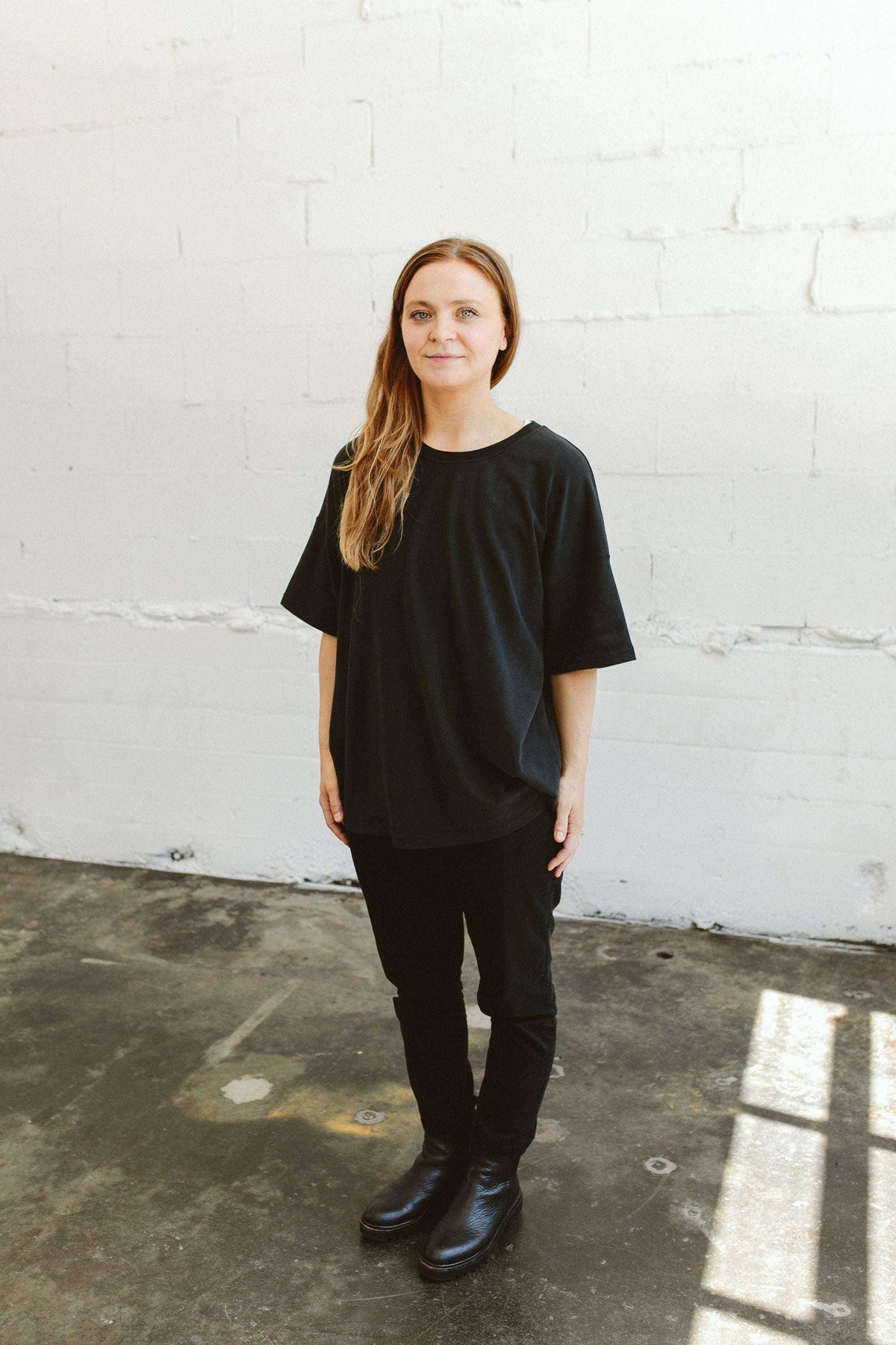 ADULT SWEATSUIT PANT in black, with a relaxed fit and soft-looking fabric, shown with a matching black top