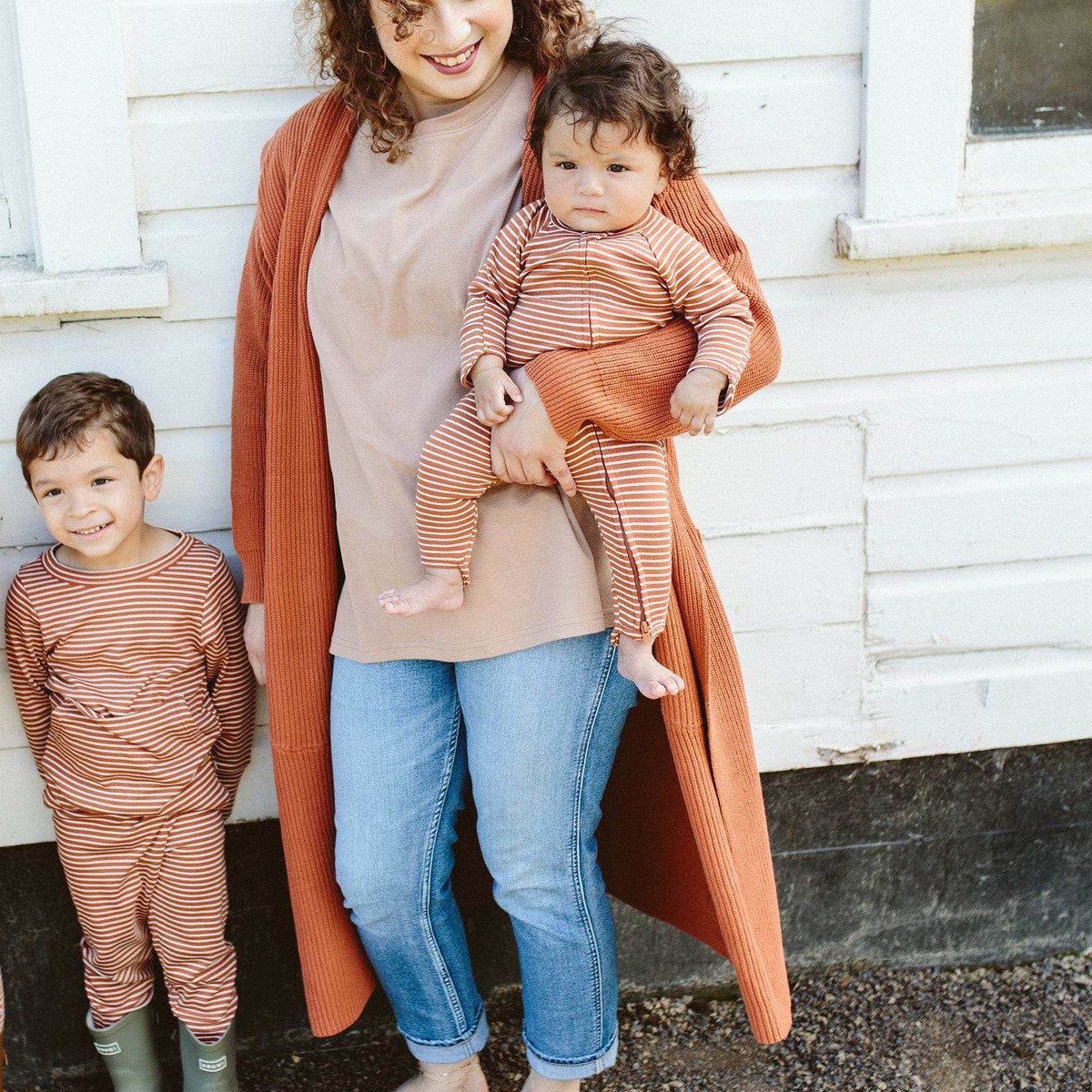 GROW WITH YOU FOOTIE in rust and cream stripes, a soft long-sleeve baby romper with a two-way zip