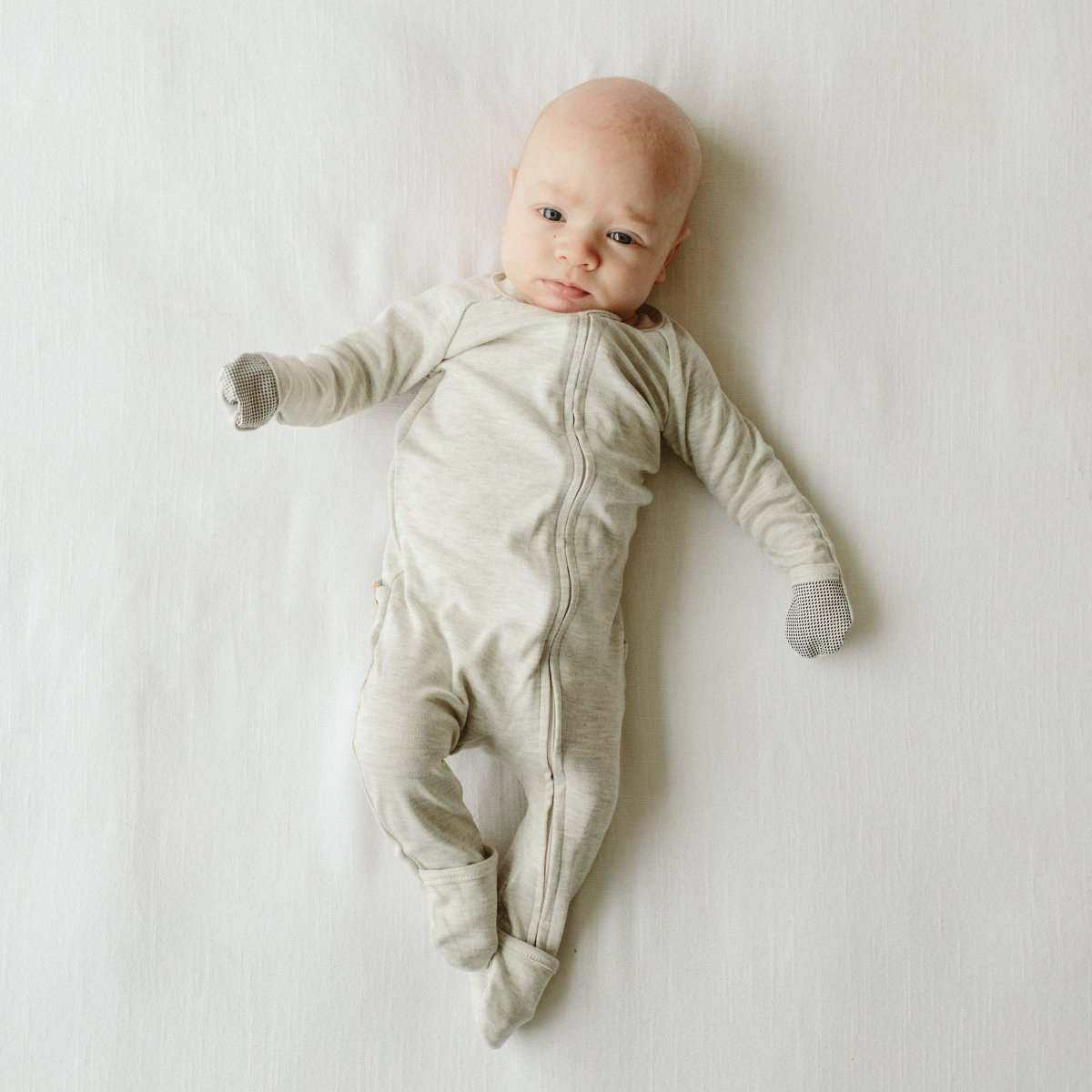 GROW WITH YOU FOOTIE in storm gray, a soft solid-color long-sleeve baby footie with a two-way zipper and built-in mitts