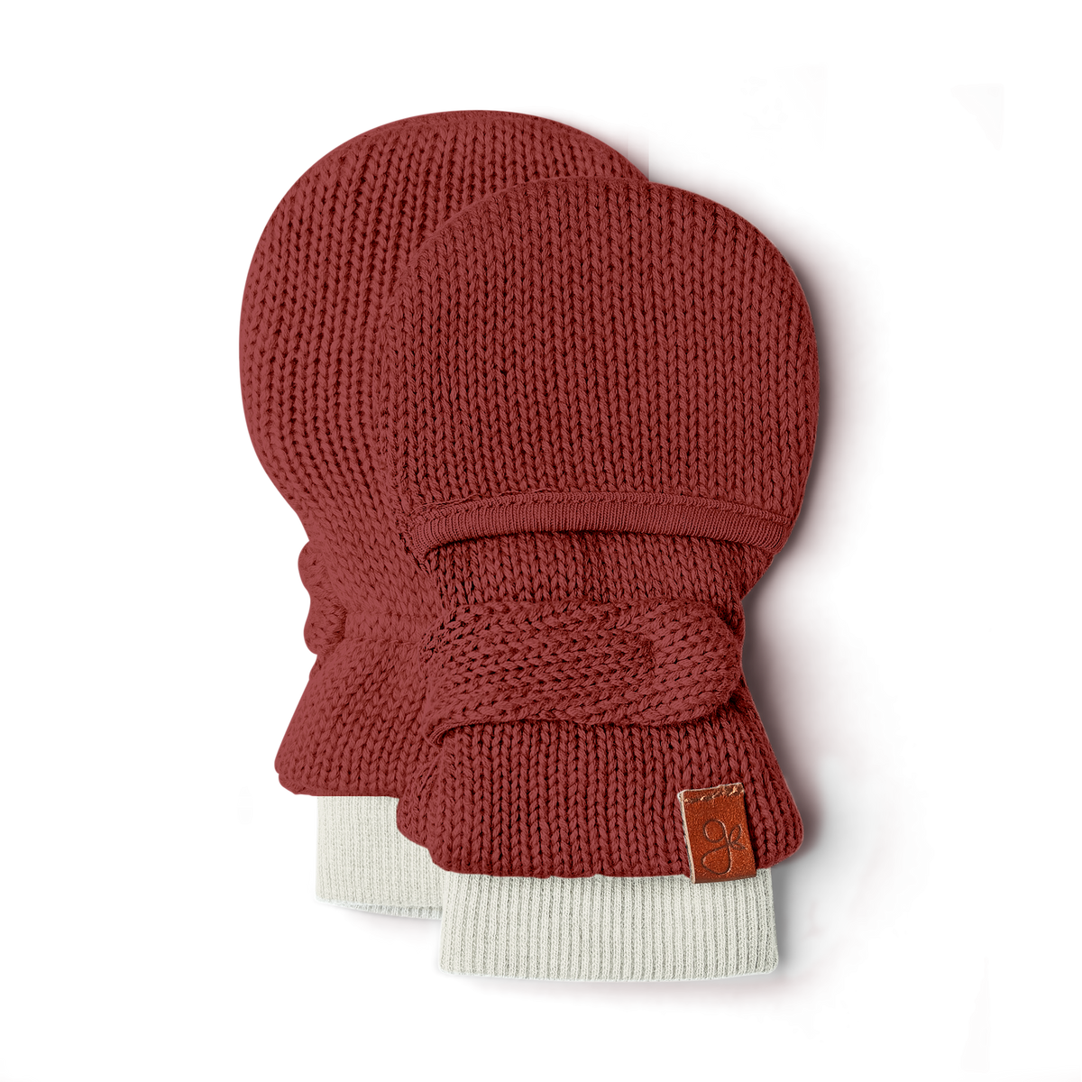 KNIT MITTS in rust-red knit with wide cream ribbed cuffs, a matching wraparound fastening and leather label