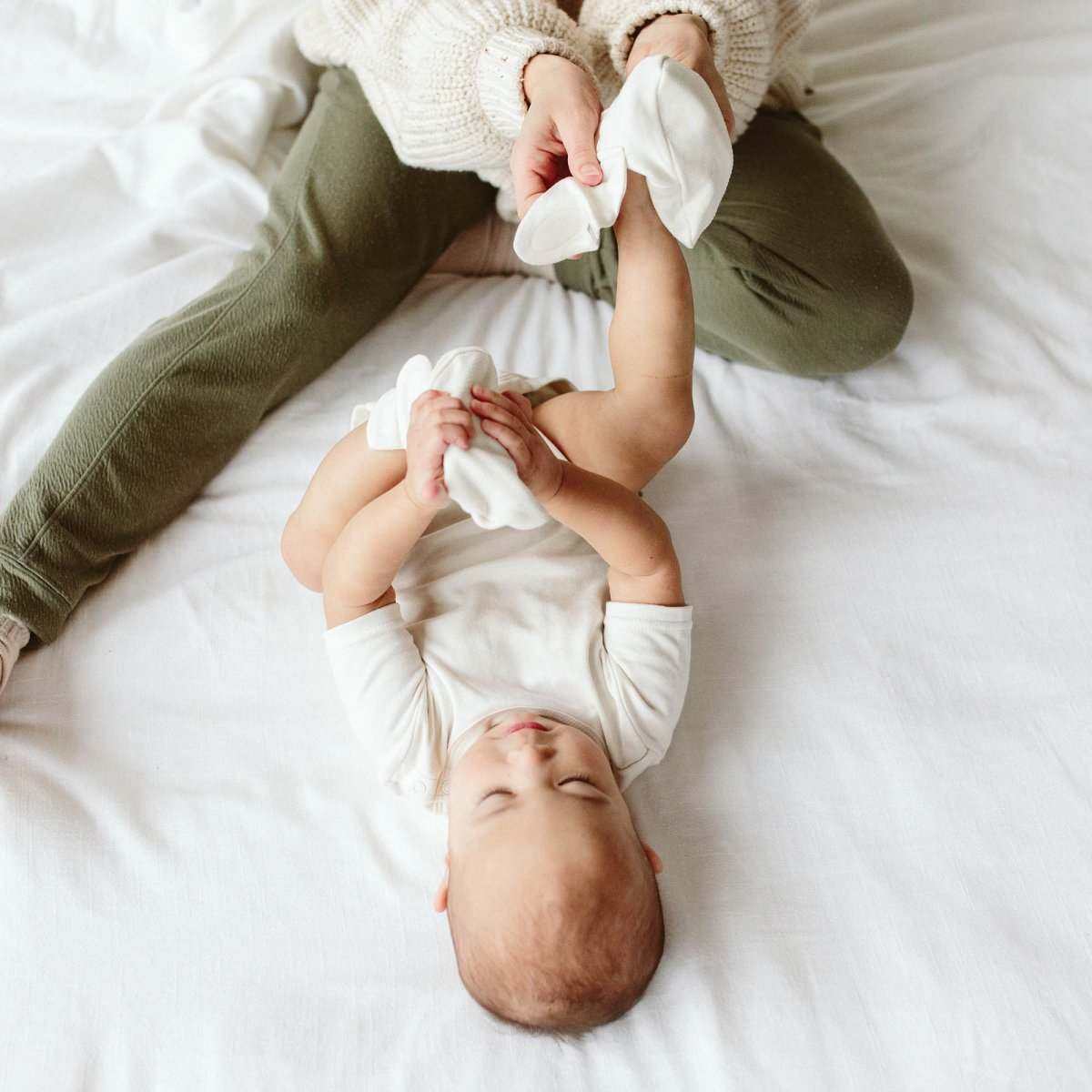 PREEMIE BOOTS are soft white baby boots with a smooth fabric finish and adjustable wraparound closures