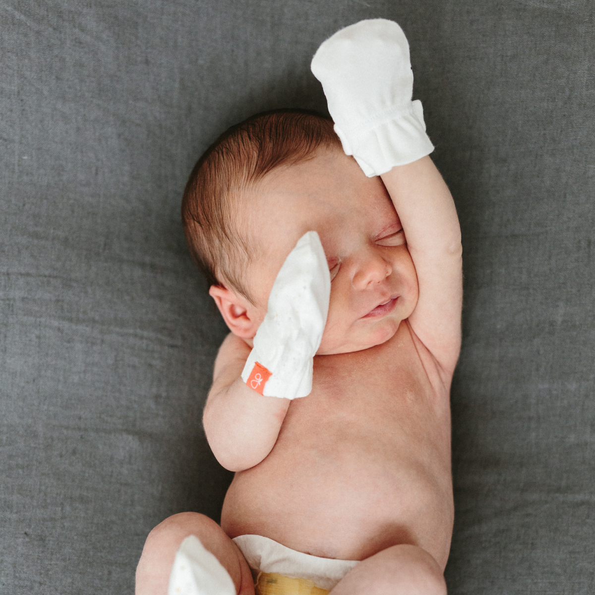 Preemie Sleep Set with a newborn wearing white cotton mitts, showing soft fabric and secure wrist cuffs