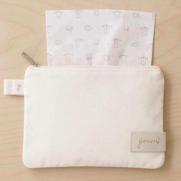 Quiet Night Starter Set featuring a cream fabric pouch with a stitched logo tab and a soft baby-clothes print lining