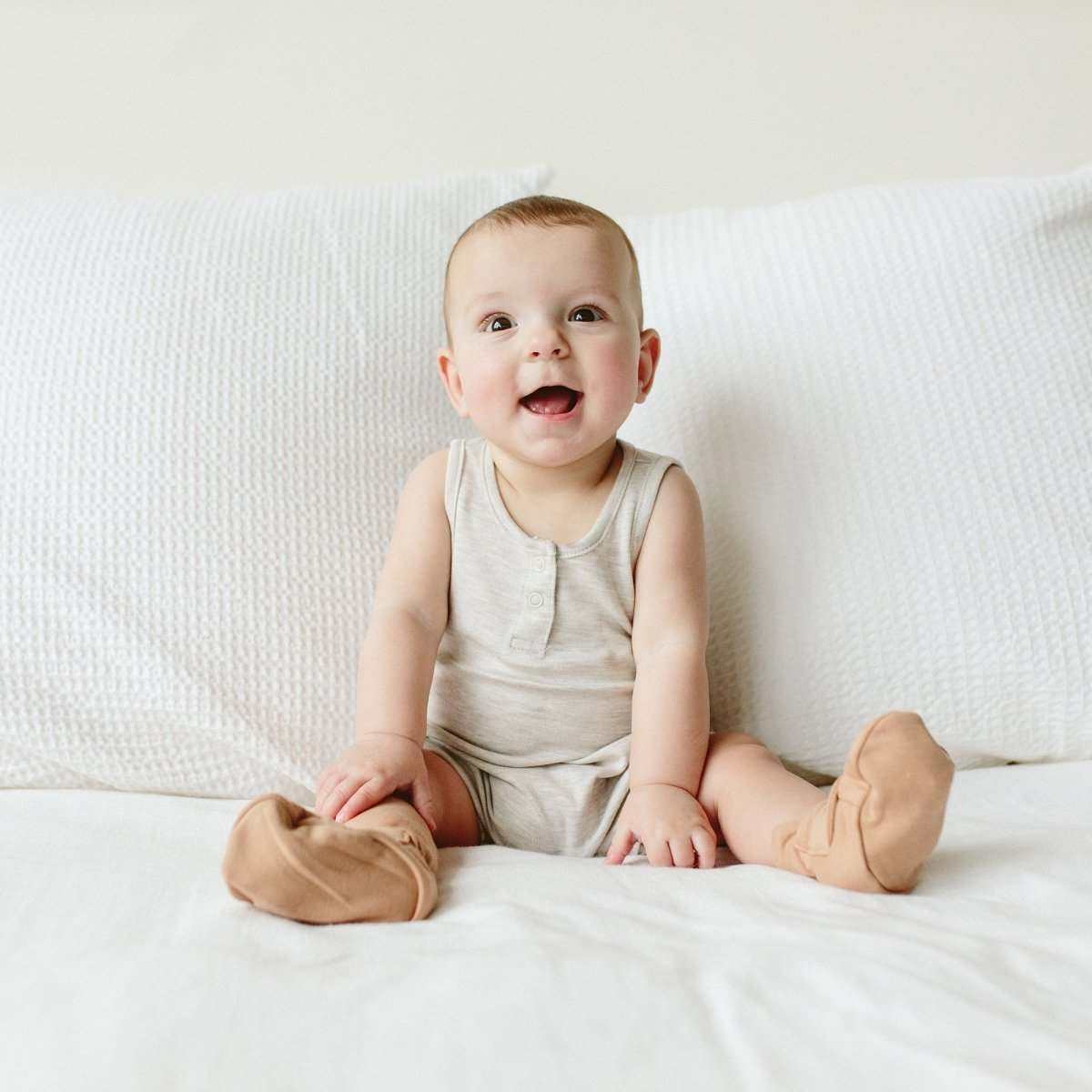 Quiet Night Starter Set with a baby wearing a cream sleeveless gown and soft sandstone-colored stay-on boots
