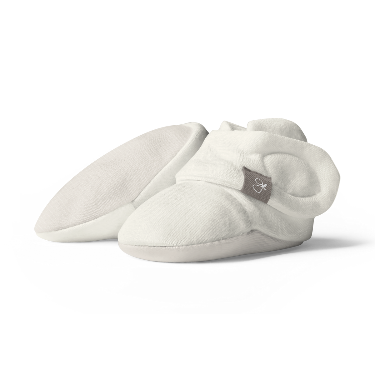 Quiet Night Starter Set featuring soft white knit baby booties with folded cuffs, rounded toes, and a small woven label