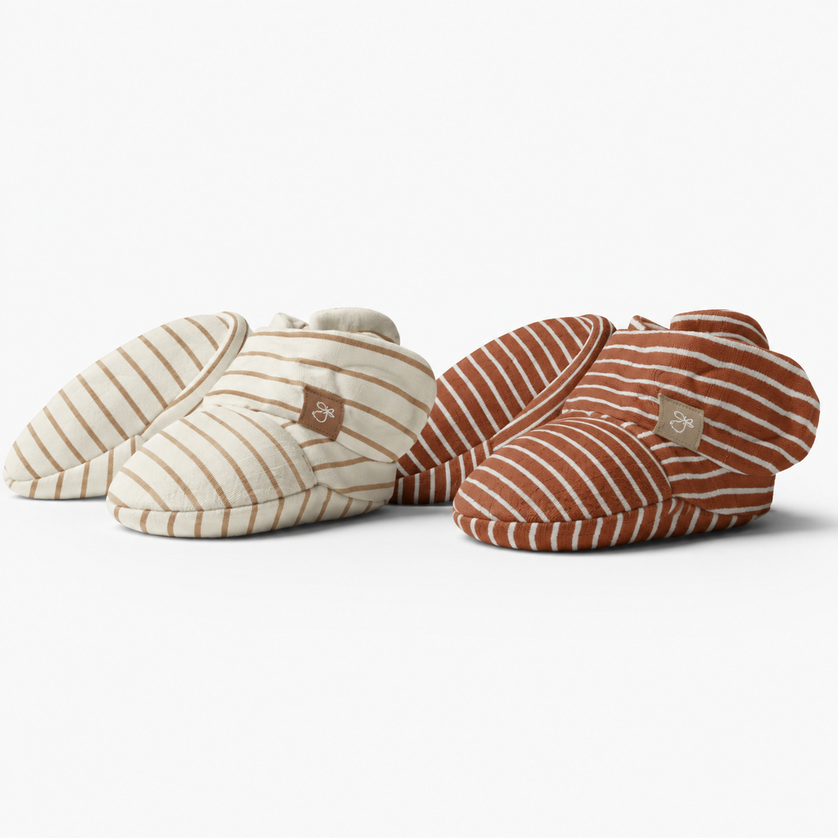 STAY ON 2-PACK BOOTS are soft baby booties in cream and rust with contrasting stripes and adjustable wrap closures