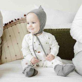 STAY ON 2-PACK BOOTS in soft gray fabric, worn by a baby with an adjustable wraparound closure