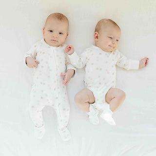 STAY ON 2-PACK BOOTS in pale printed fabric, worn by two babies with soft adjustable ankle closures