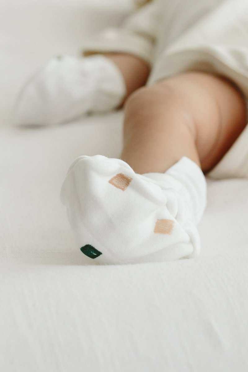 STAY ON 2-PACK BOOTS in soft white fabric with small muted geometric accents and an adjustable wrap closure