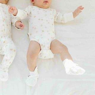 STAY ON 2-PACK BOOTS with white baby booties featuring a soft fabric finish and adjustable wrap closure