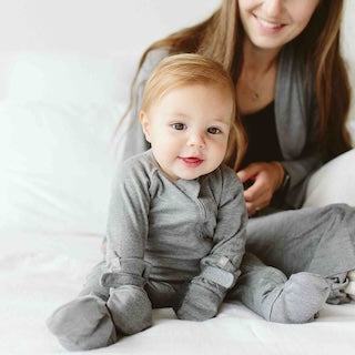 STAY ON 2-PACK MITTS in soft gray fabric, worn by a baby with a two-part closure at the wrists