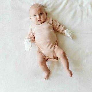STAY ON 2-PACK MITTS in soft white fabric with a black-and-white patterned cuff, worn by a baby