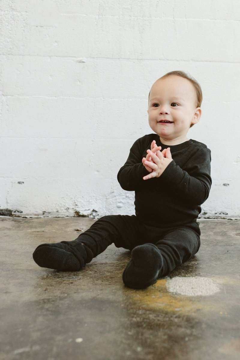 Stay On Boots in asphalt black, soft fabric baby booties with an adjustable wraparound closure