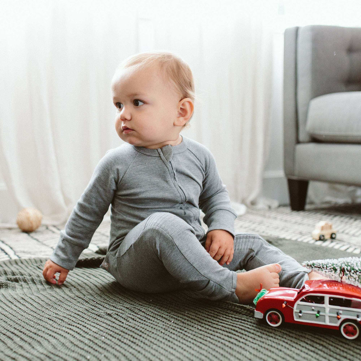 Welcome Home Set features a baby wearing a soft gray cotton footie with a front snap closure and covered feet