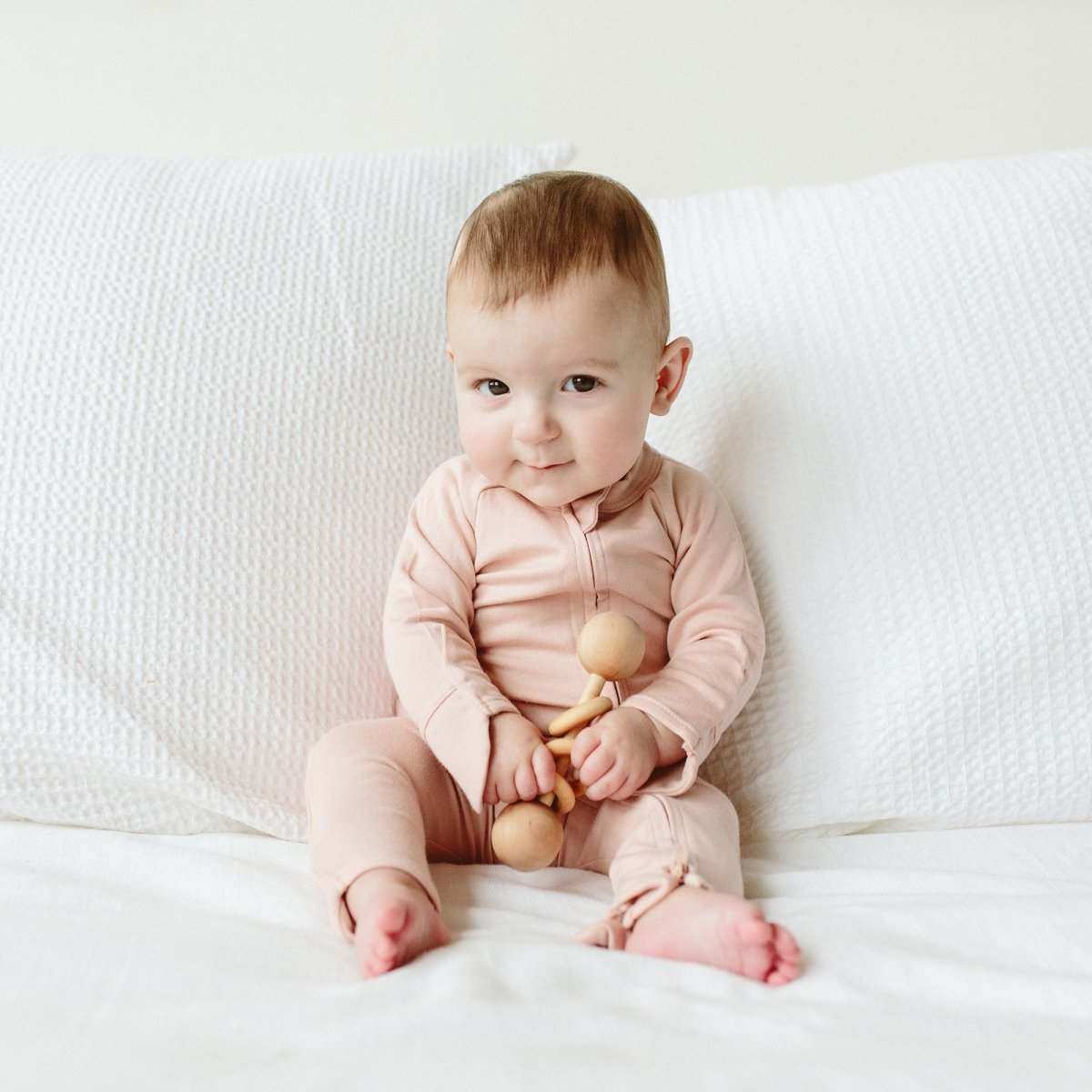 Welcome Home Set in rose pink, featuring a soft long-sleeve baby gown with a crossover front and fold-over cuffs