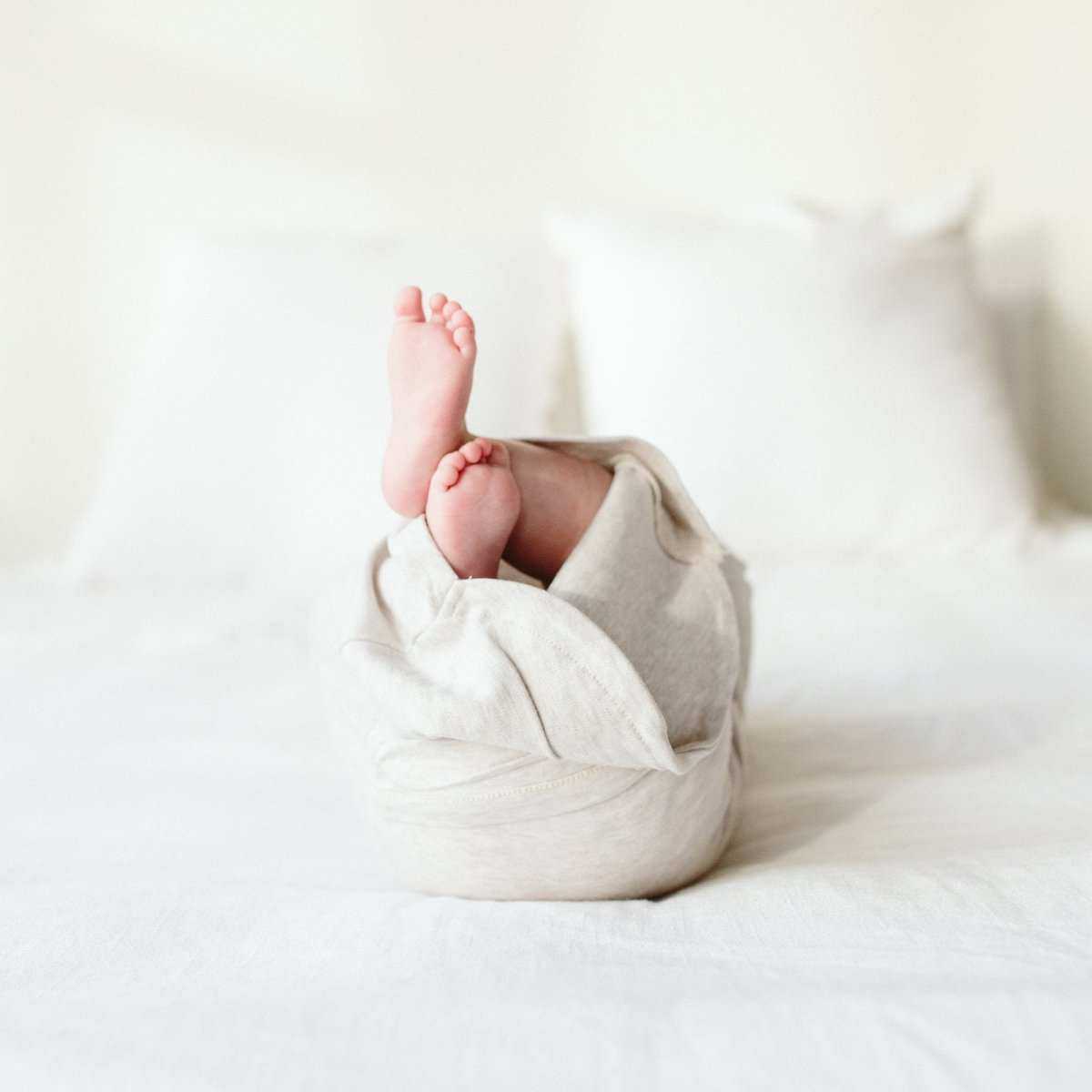 24 HOUR CONVERTIBLE GOWN in storm gray, a soft solid-colored baby sleeper gown with a convertible wrap-style opening