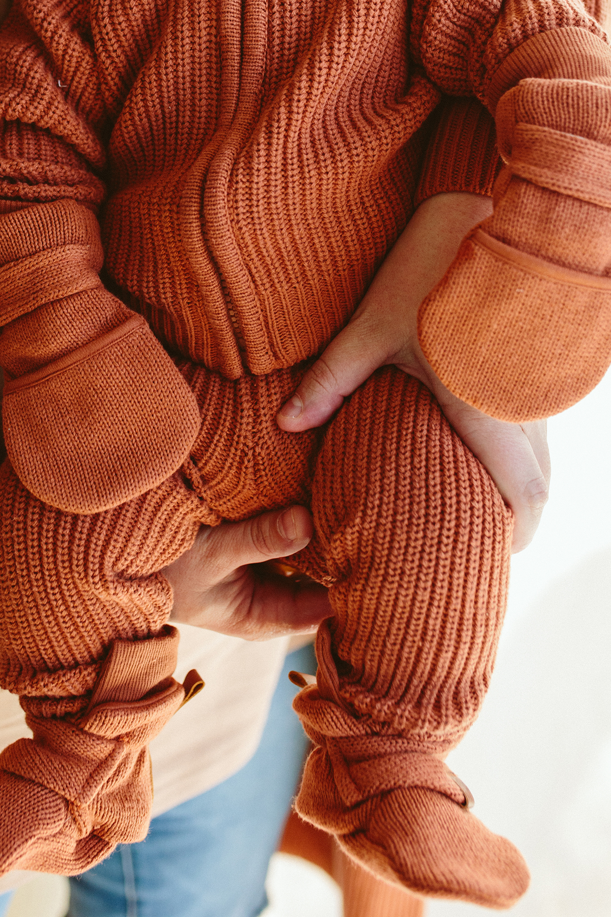 Knit Mitts in rust clay ribbed knit with soft rounded palms and wide adjustable wrist closures