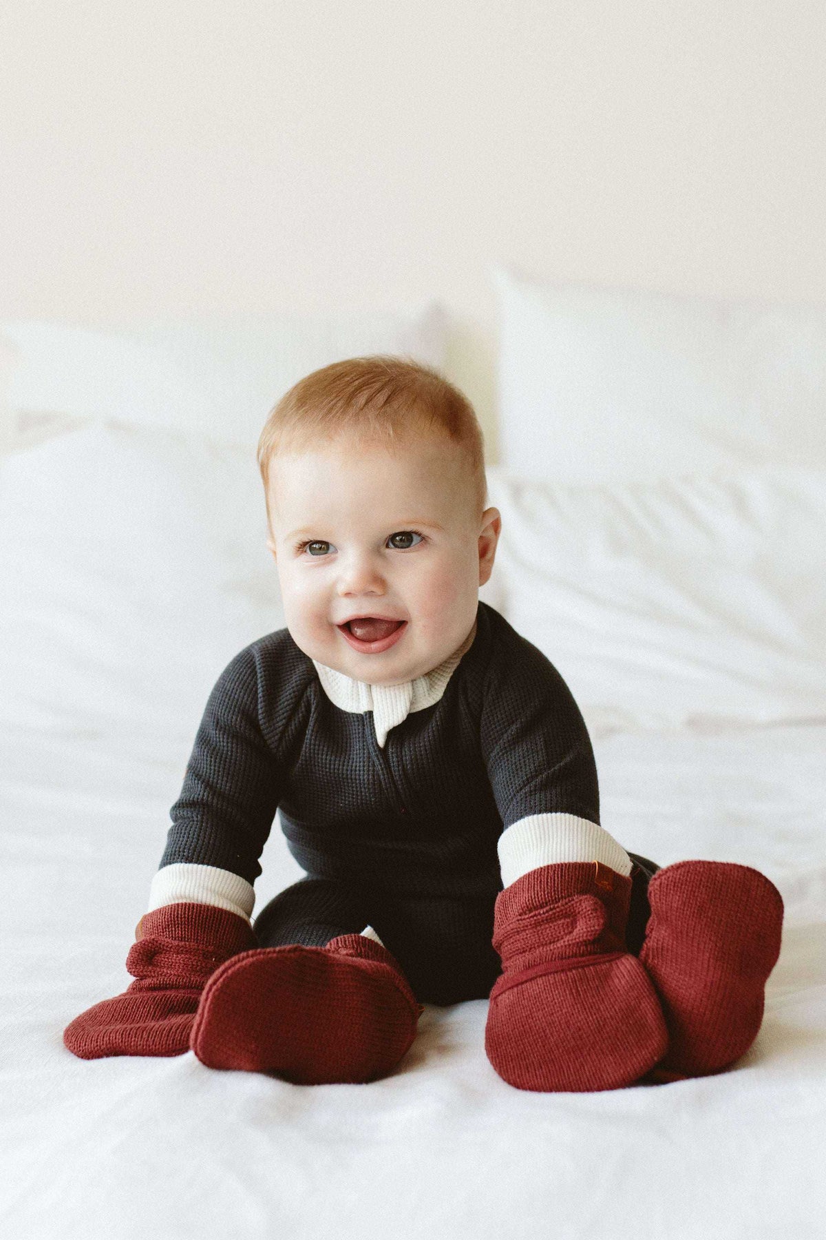 KNIT MITTS in deep red chunky ribbed knit, worn by a baby with matching wrist cuffs