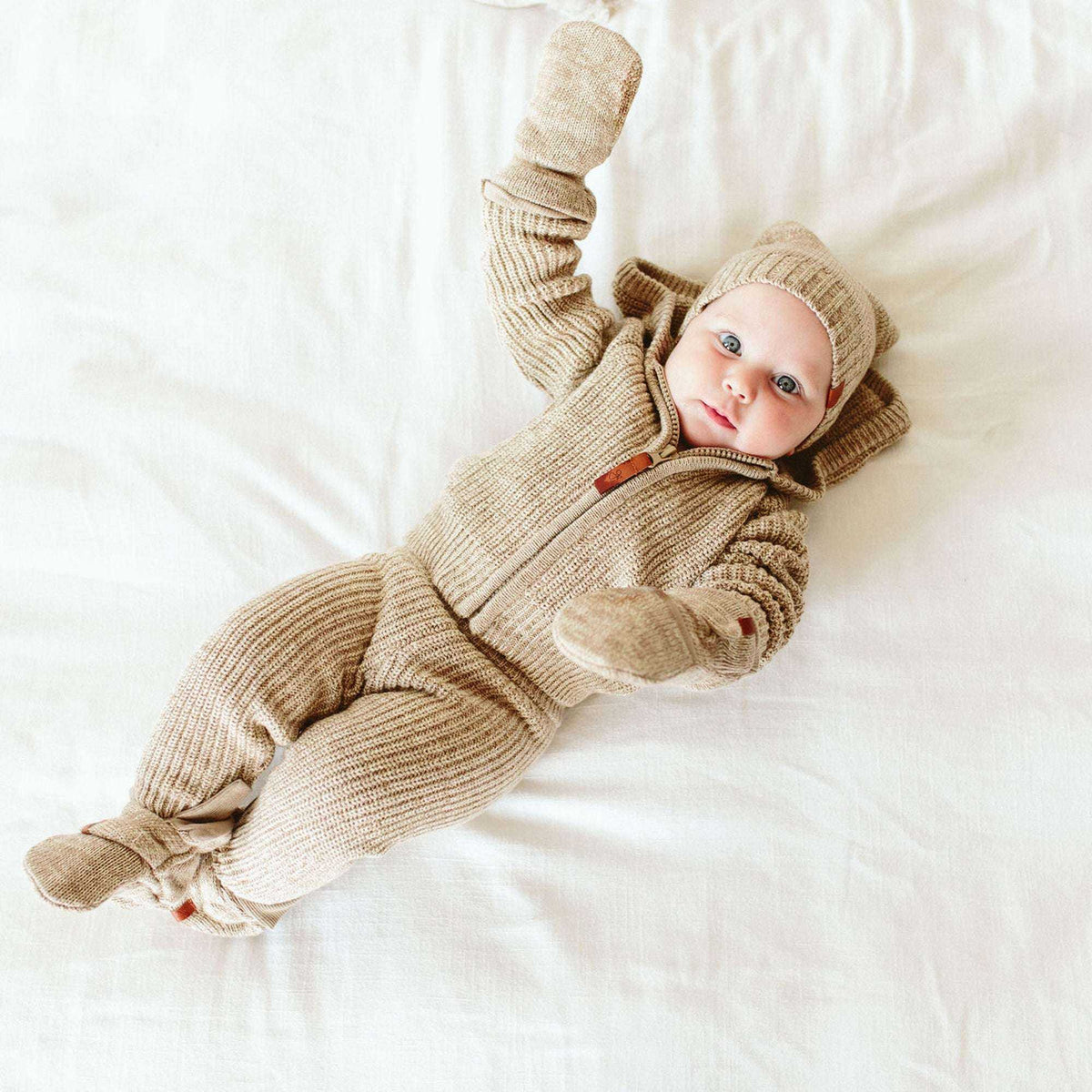 KNIT MITTS in oatmeal beige ribbed knit, matching a baby’s cozy outfit with soft cuffs and enclosed hands.