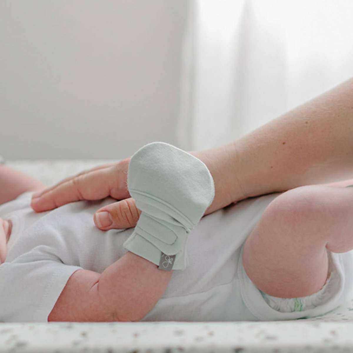 STAY ON MITTS baby hand mitt in pale mint green, with a soft fabric finish and adjustable wrap closure