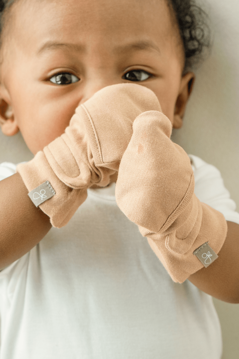 Goumi Kids Sandstone Baby Layette Gift Set – stay-on mitts & boots, convertible sleeper gown, grow-with-you footie, gift-packaged – flat lay